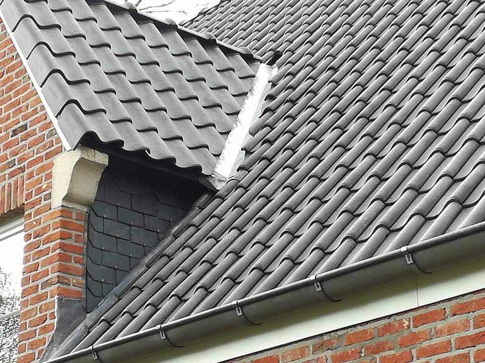 Detail van nieuwe dakpannen met zinken dakgoot